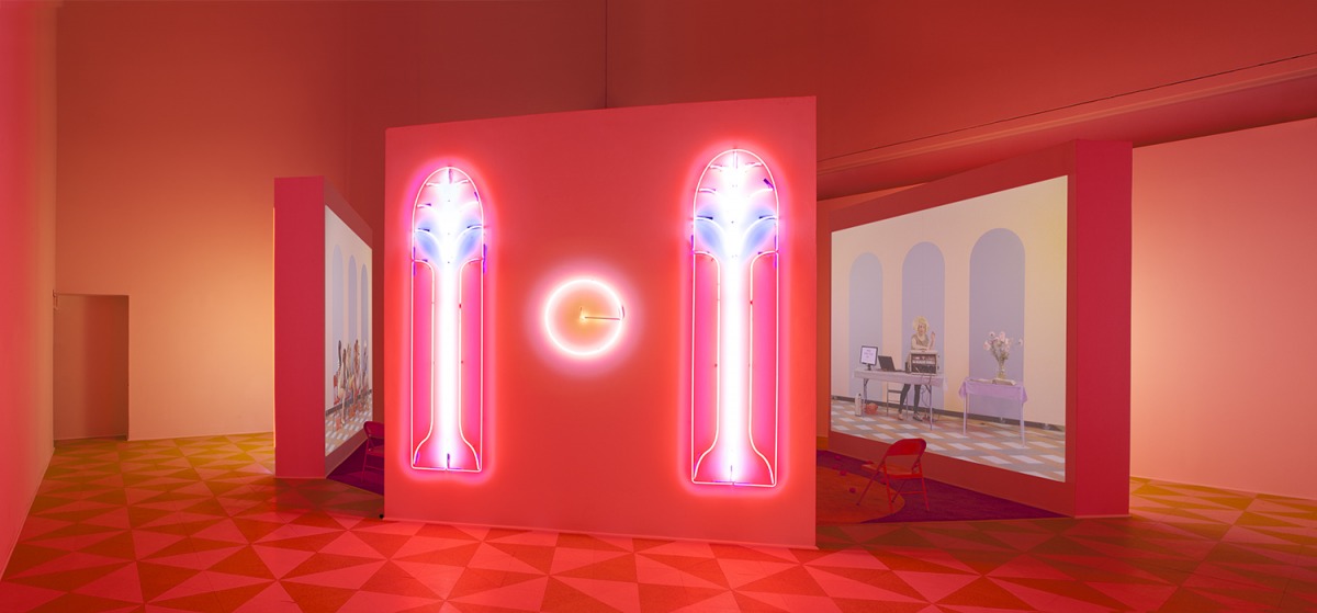 Alex Da Corte (b. 1980) and Jayson Musson (b. 1977). Easternsports, 2014. Four-channel video, color, sound; 152 min., with four screens, neon, carpet, vinyl composition tile, metal folding chairs, artificial oranges, orange scent, and diffusers. Score by 